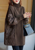 Warm oversized women's sweater with a turtleneck and quilted inserts