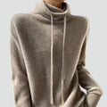 Loose-fitting women's oversized sweater with a drawstring turtleneck