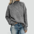Warm women's sweater with a cable-knit pattern and a stand-up collar